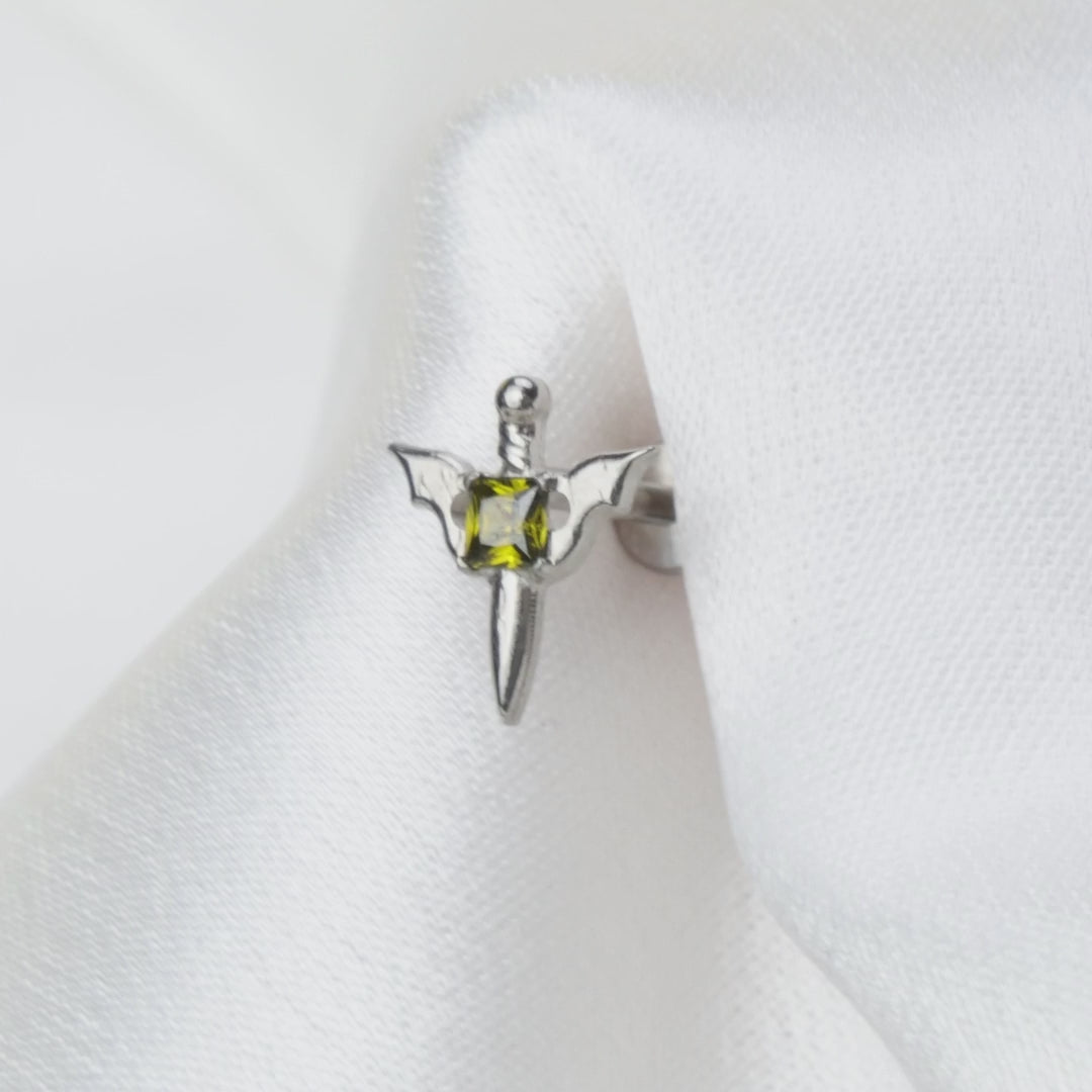 Load video: Titanium Clio Little Peridot Sword Flat Back Stud